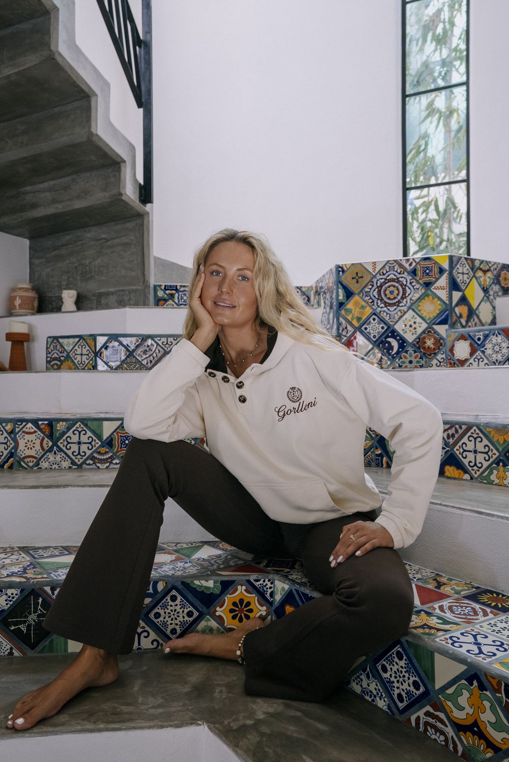 Amy modeling on a tiled staircase