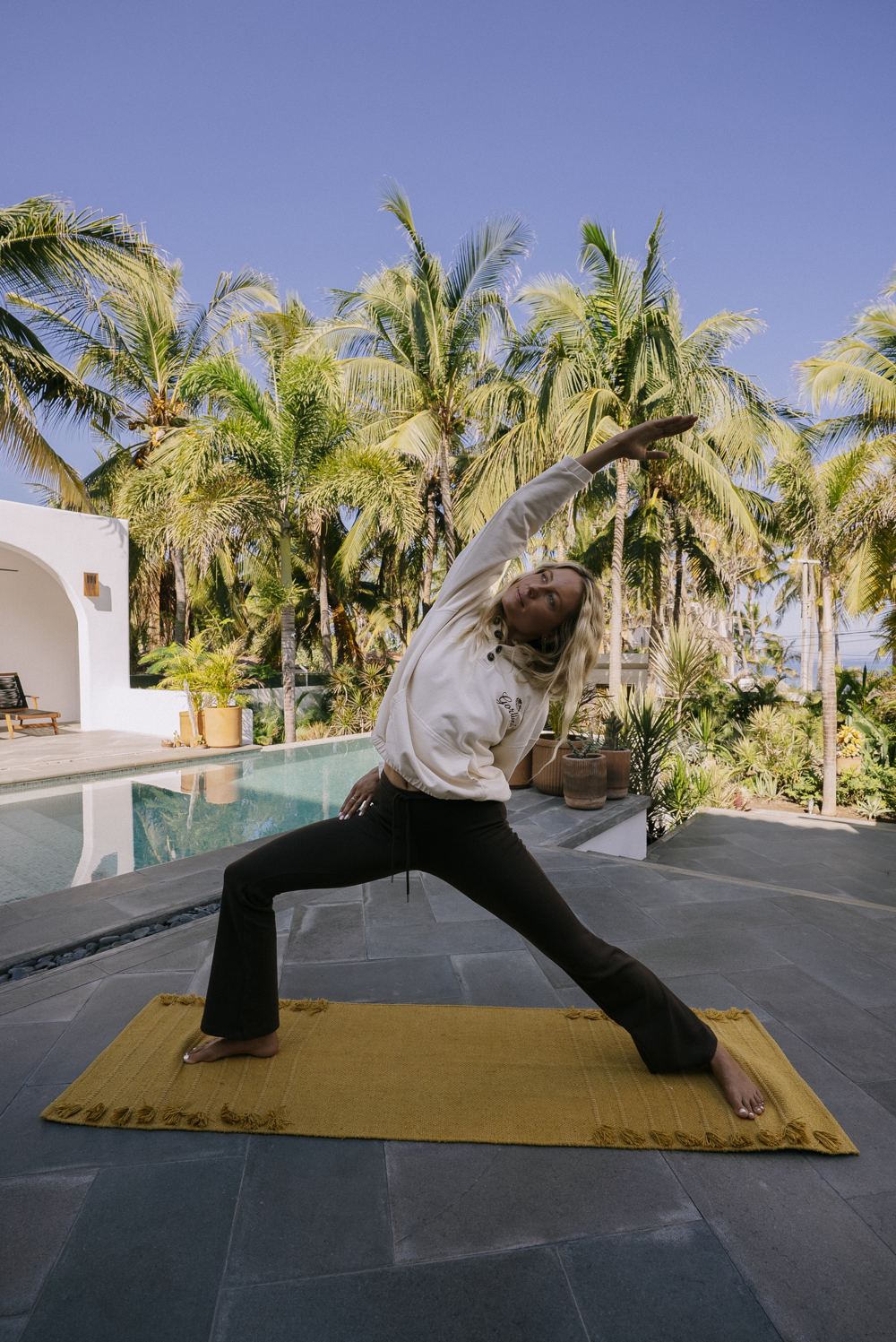 Amy modeling poolside in a yoga pose